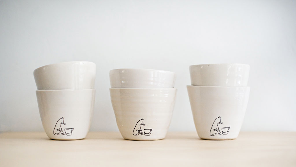 Comins tea bowls, with logo inspired by their cat, Anders.